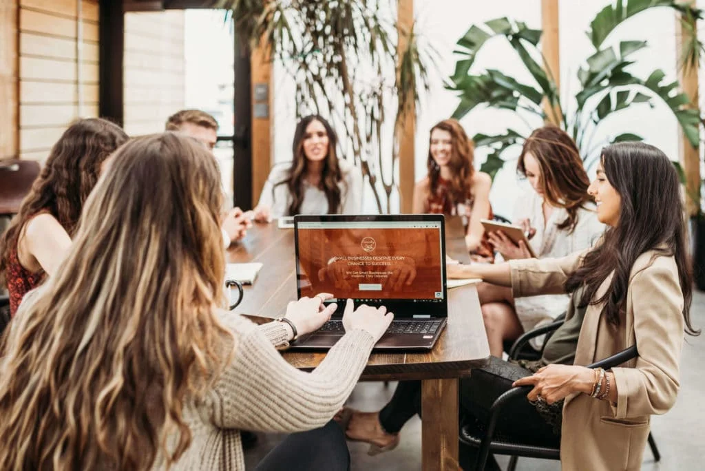 Succeeding Small team gathered around table