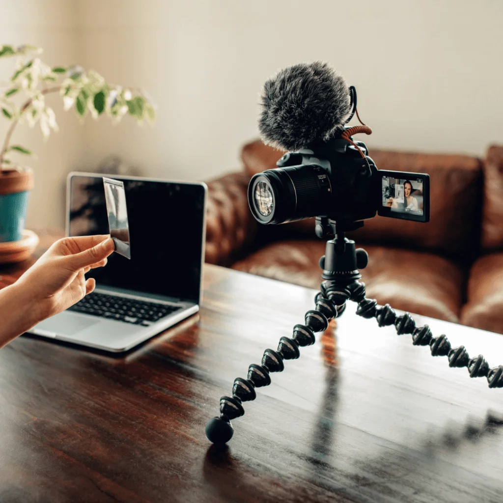A picture of someone filming themselves while they hold a picture up to the camera.