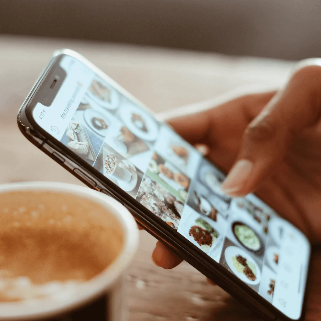 A picture of someone scrolling through a social media app on their phone.