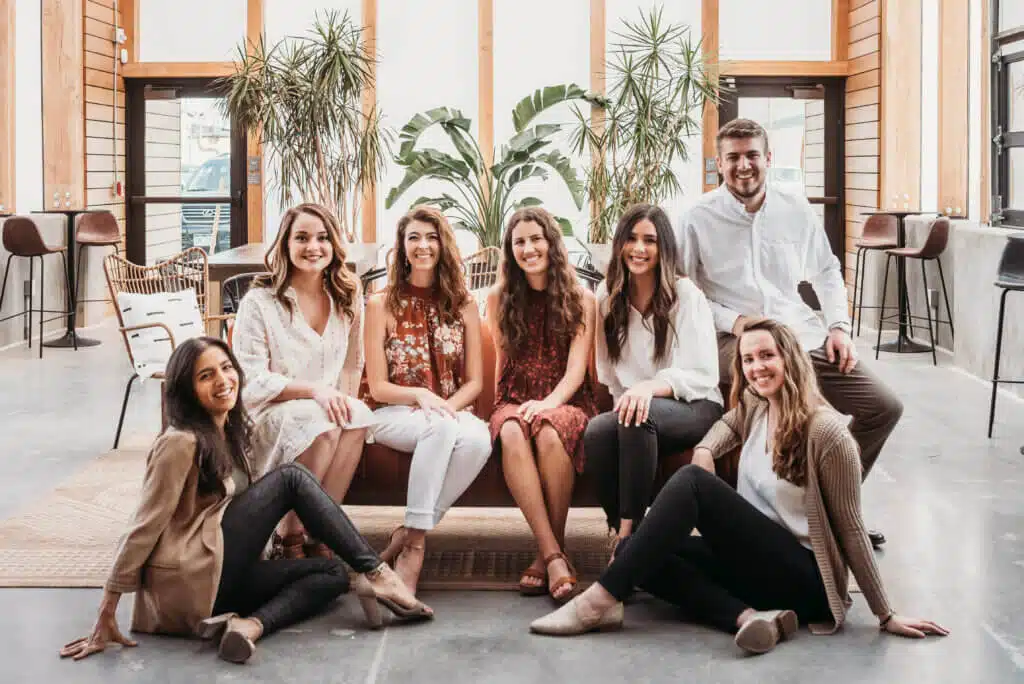 Photo of the Succeeding Small Digital Marketing team sitting on a couch.