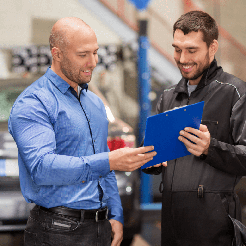 A picture of two happy mechanics doing automotive SEO.