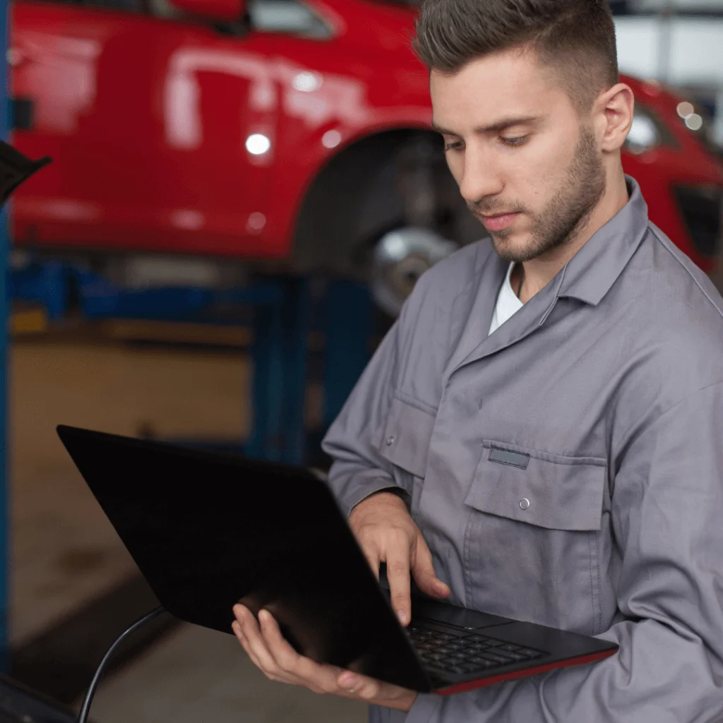 A picture of a mechanic looking at a computer doing SEO.