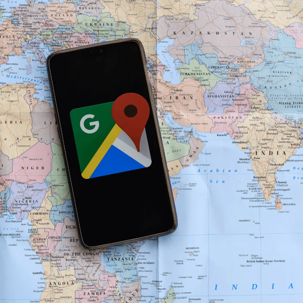 a closeup of a cell phone with the google maps logo