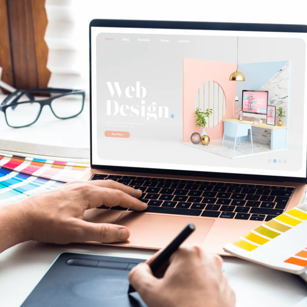A closeup of someone designing a colorful website on a laptop