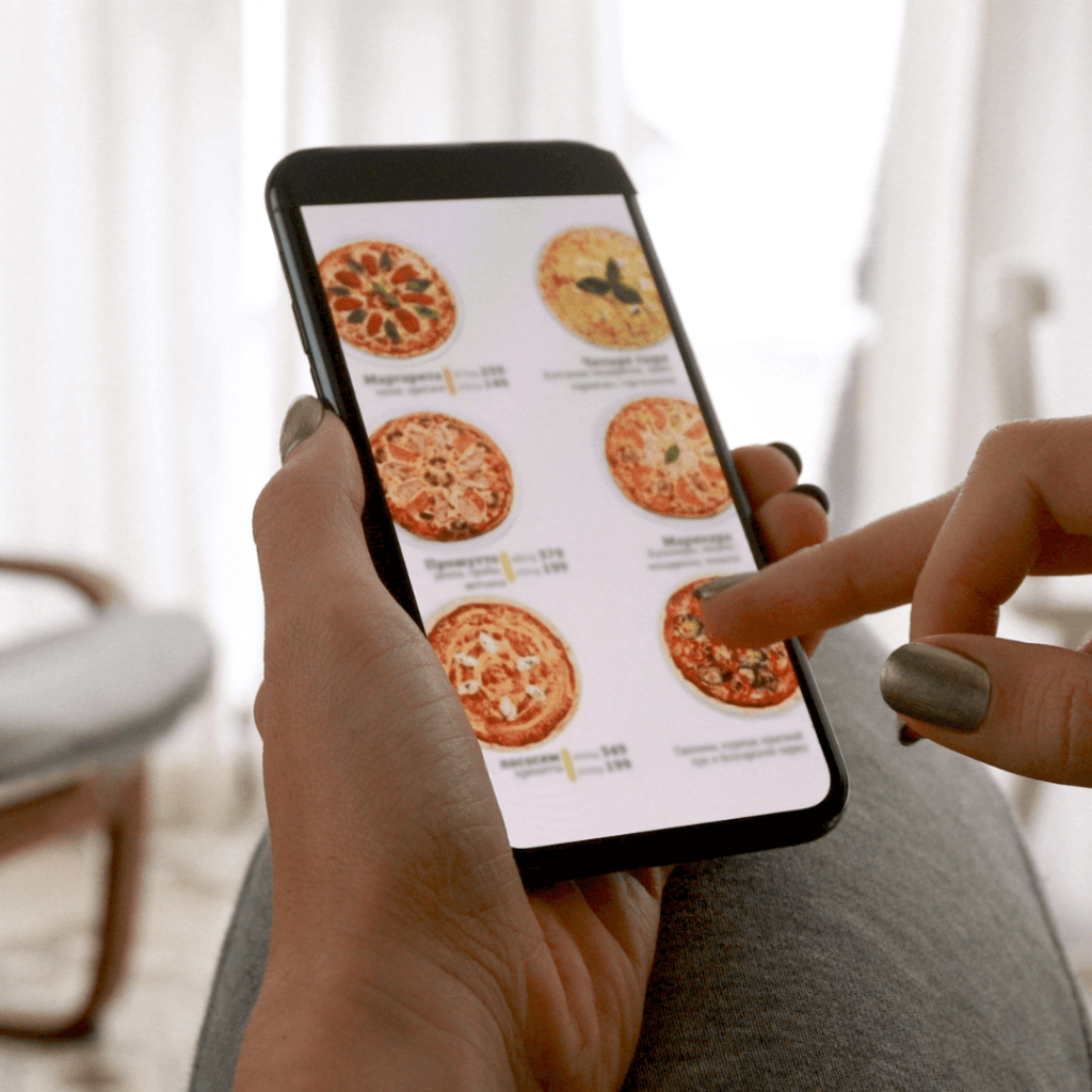 Someone ordering a pizza on their smartphone