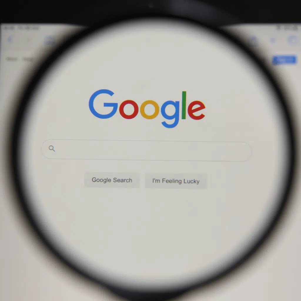 A picture of Google.com on a computer screen under a magnifying glass