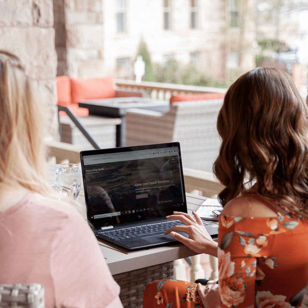 Digital marketers strategize in front of.a laptop for ppc campaign solutions.