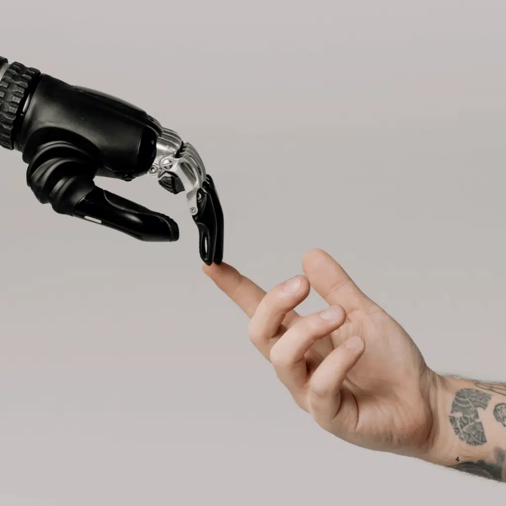 An AI robot hand reaches out to a human male hand in a blog about how to build a small business marketing plan for 2025. 